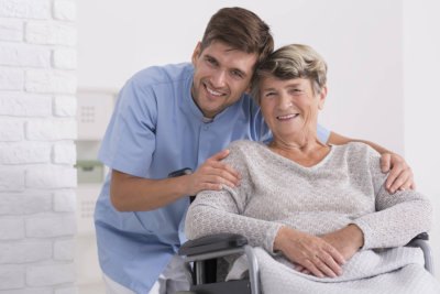 a happy nurse and a senior woman smiling